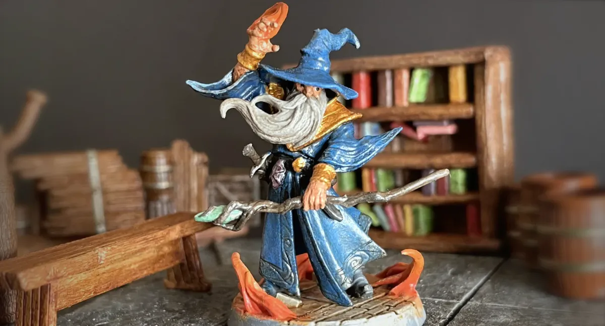 Finished Cornelius Greathat wizard miniature in a library setting