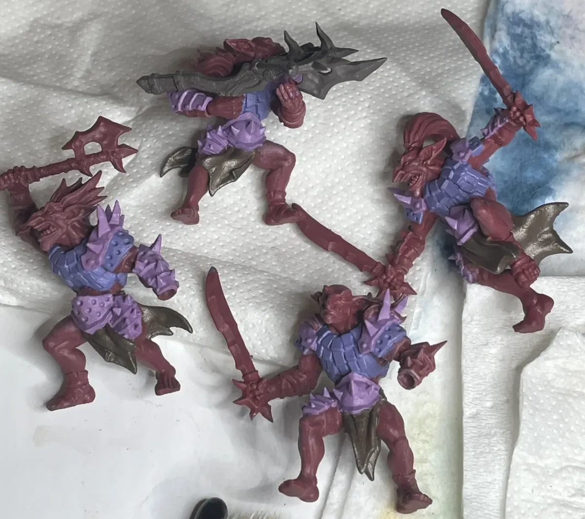 Hobgoblin miniatures with purple armor during basecoating